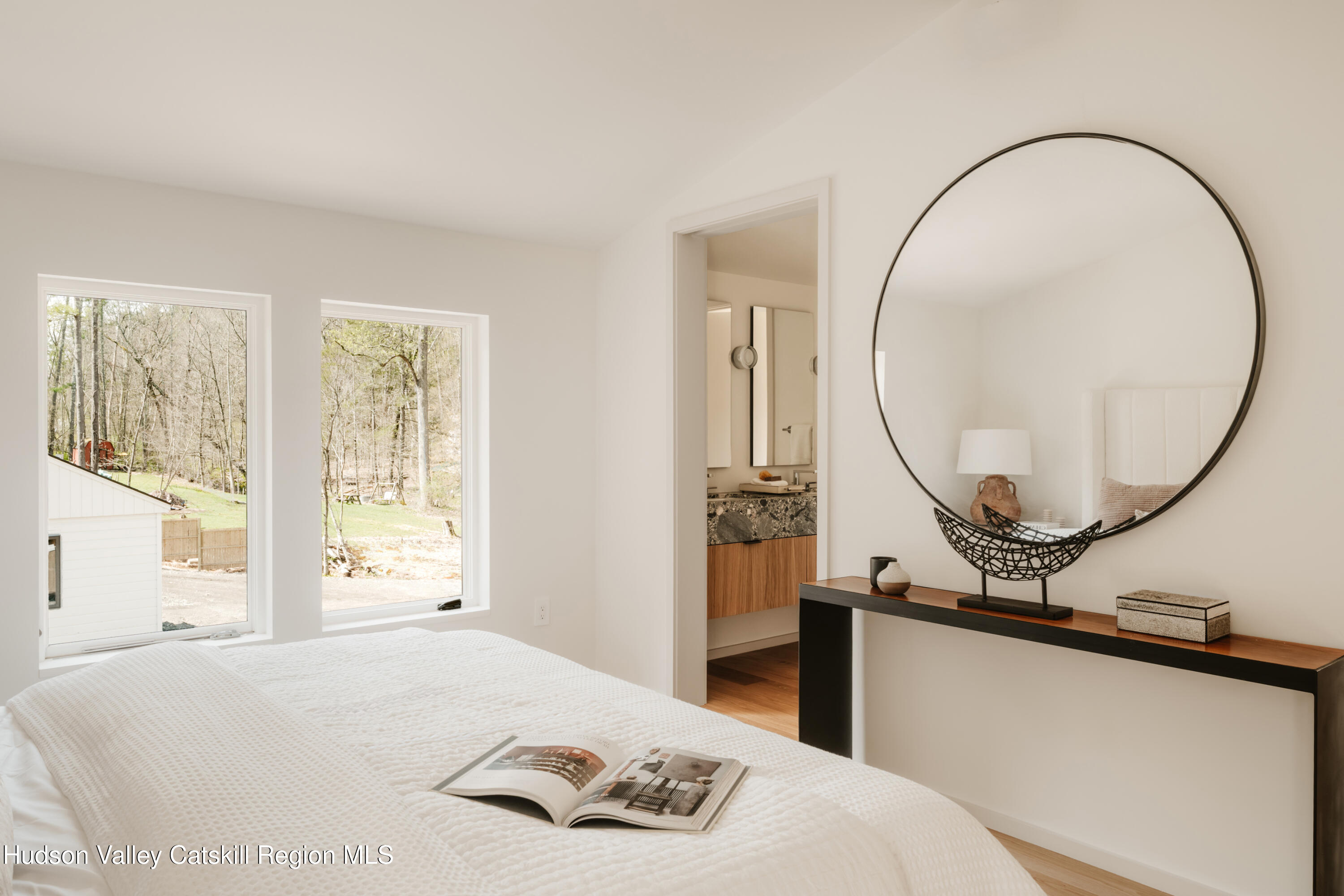 332 Mohonk Road High Falls, NY 12440 - Photo 25 of 38 a bedroom with a bed a mirror and a large window
