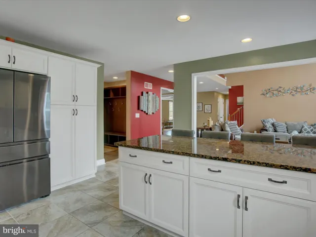 a kitchen with a refrigerator and a stove top oven