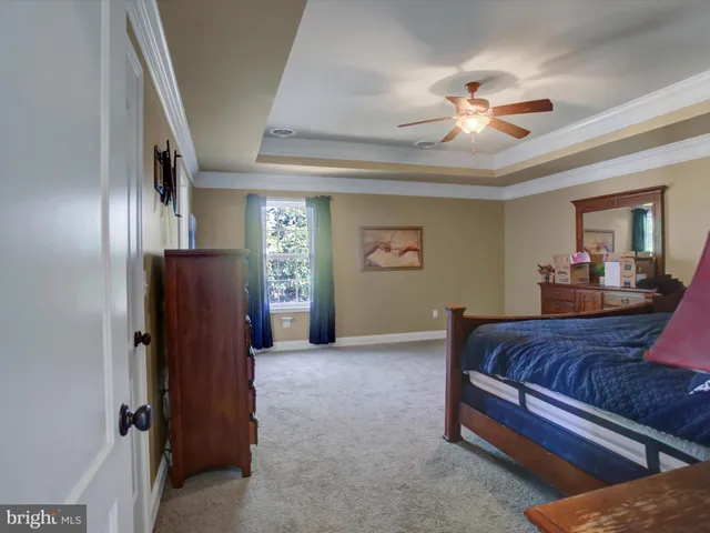 a bed room with a bed and a chandelier