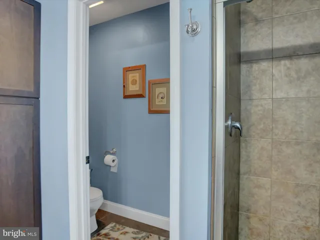 a bedroom with a large bed and a large mirror