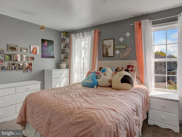 a bedroom with furniture and a window