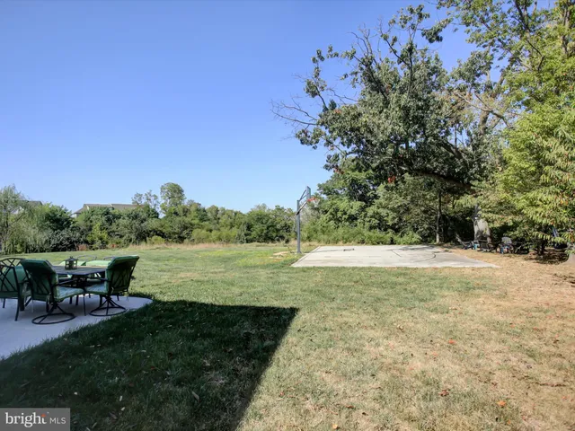 a front view of a house with a yard and seating space