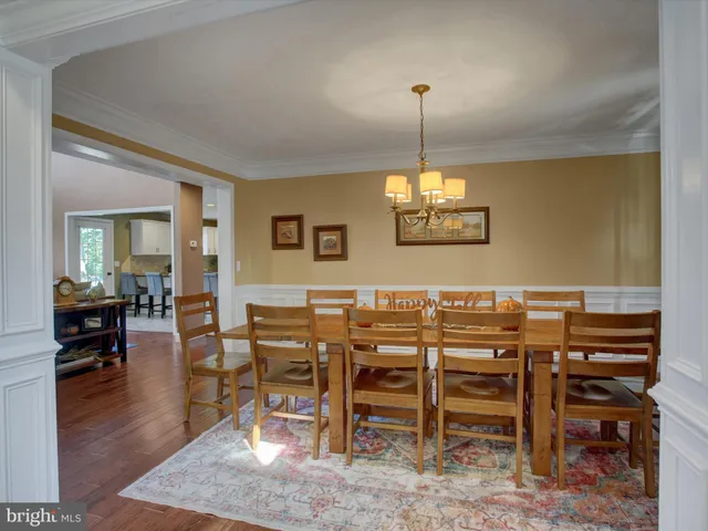 a view of a dining room with furniture wooden floor and a chandelier