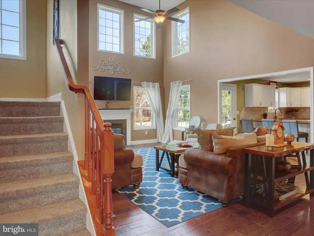 a living room with furniture a fireplace and a large window