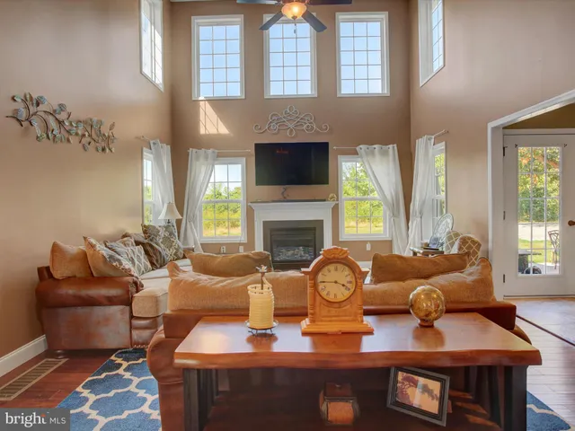 a living room with furniture fireplace and a large window