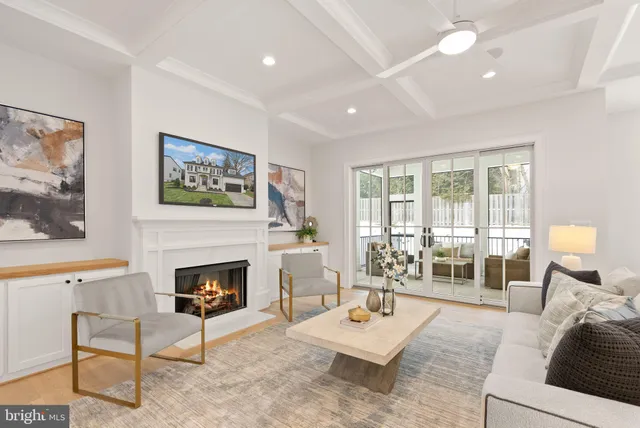 a view of a living room with a floor to ceiling window and wooden floor