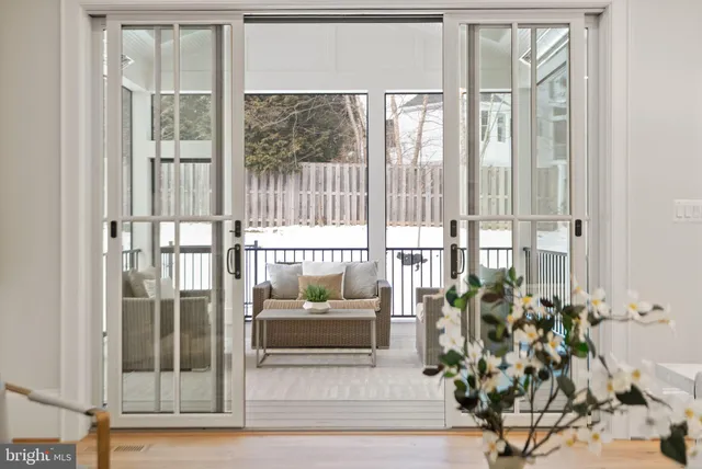 a kitchen with kitchen island a stove a table a sink cabinets and wooden floor