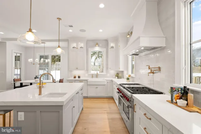 a spacious bedroom with a large bed and a chandelier
