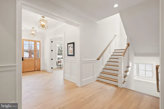 an empty room with wooden floor and white walls