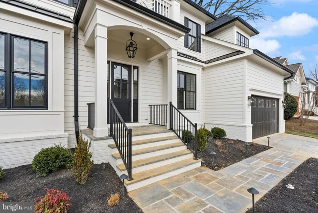a living room with furniture a chandelier and a large window