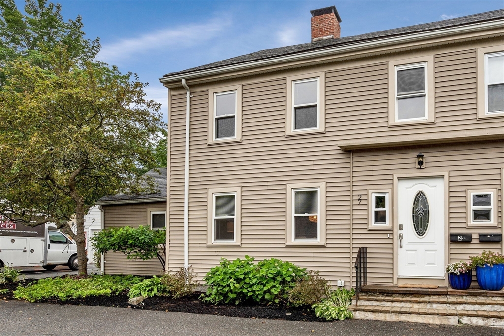 27 Water Street, Unit 27 Concord, MA 01742 - Photo 20 of 20 a view of a house with a yard and potted plants
