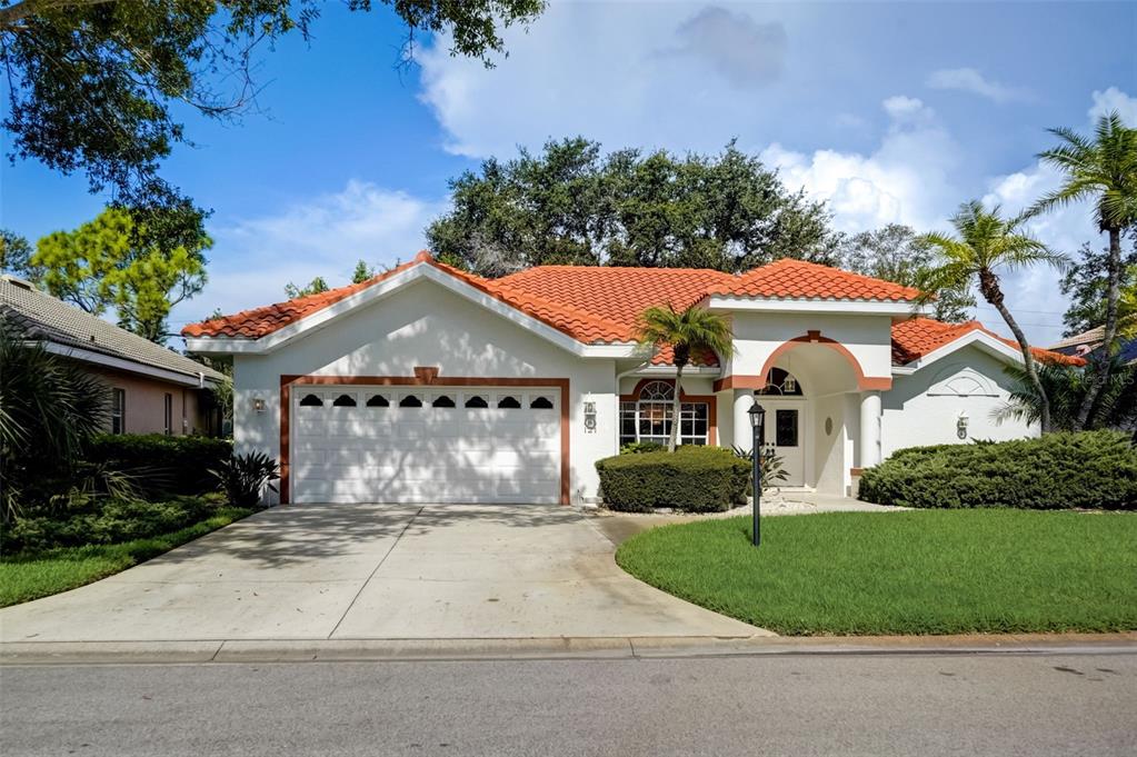 121 Wayforest Drive Venice, FL 34292 - Photo 1 of 1 a front view of a house with a yard and garage