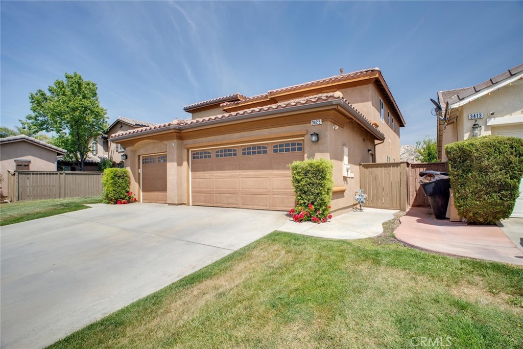 a front view of a house with a yard and a garage