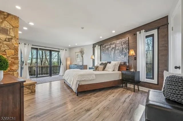 a spacious bedroom with a large bed and a large window