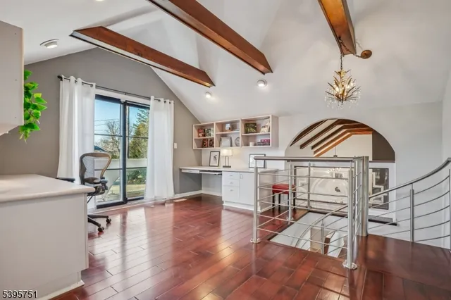 a livingroom with furniture a rug a fireplace and wooden floor