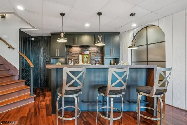 a kitchen with stainless steel appliances kitchen island granite countertop a dining table chairs and granite counter tops