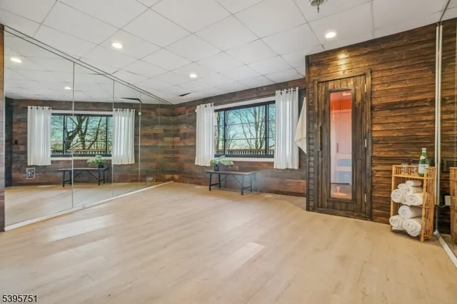 a view of an empty room with a fireplace and a large window