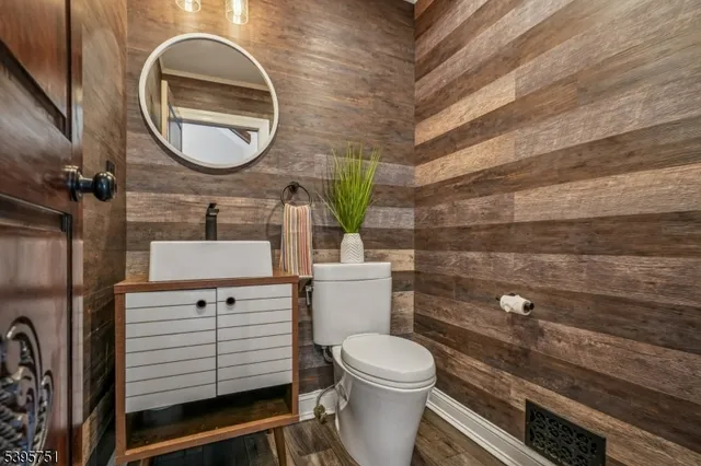 a bathroom with a toilet a sink and mirror