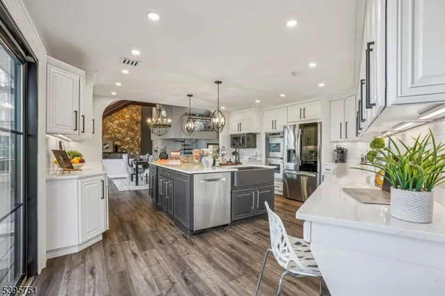 a kitchen with sink cabinets and wooden floor