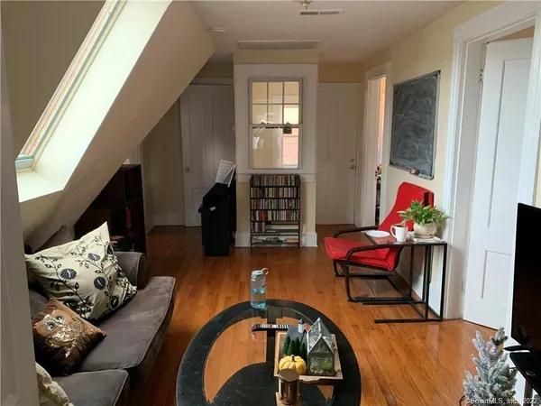 a living room with furniture chess table and a fireplace