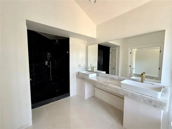 a bathroom with double vanity sinks and a bathtub