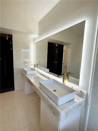 a bathroom with a sink a vanity and a mirror