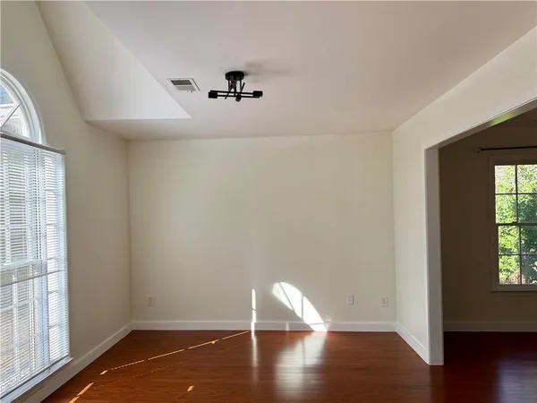 a view of room with hardwood floor and window