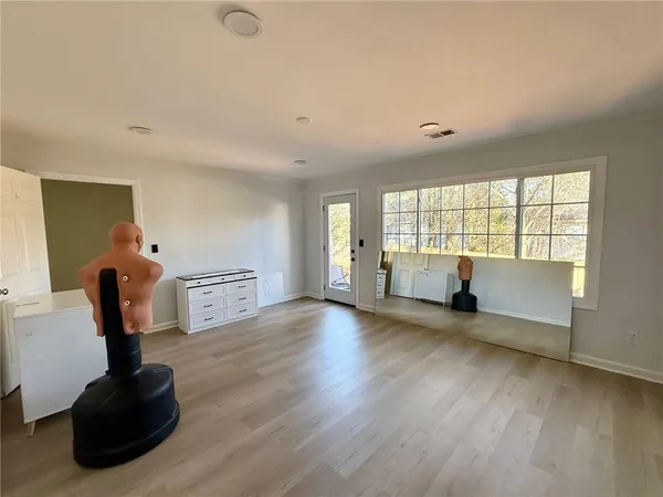 a view of a yard with plants and trees