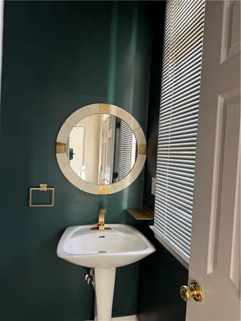 a bathroom with a sink and mirror