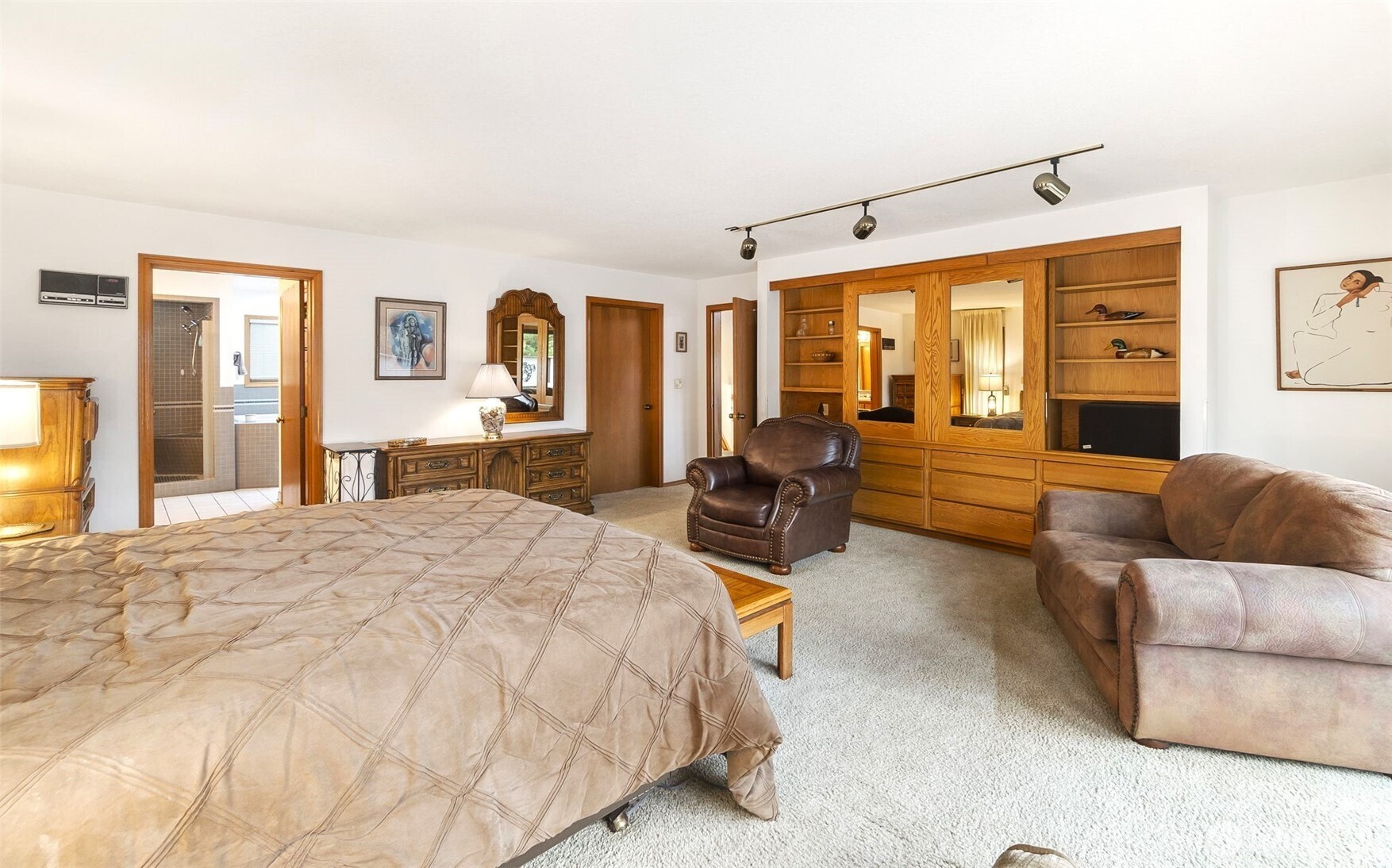 280 Surf Street Westport, WA 98595 - Photo 18 of 35 a spacious bedroom with a bed couch and a dresser next to a window