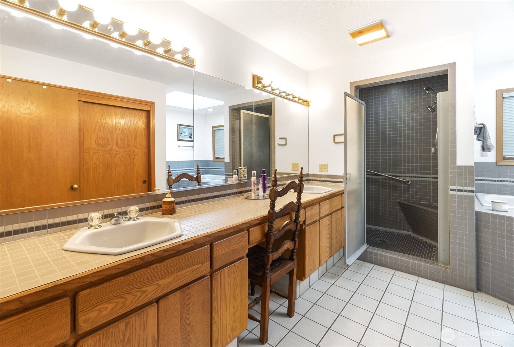 280 Surf Street Westport, WA 98595 - Photo 19 of 35 a spacious bathroom with a shower a sink and a mirror