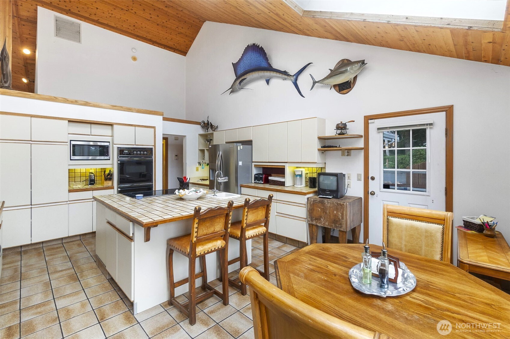 280 Surf Street Westport, WA 98595 - Photo 10 of 35 a kitchen with stainless steel appliances granite countertop a stove and a dining table