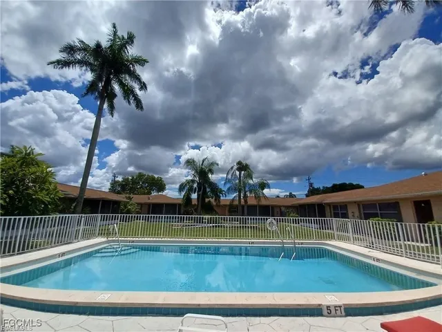 a view of swimming pool with a patio and a yard