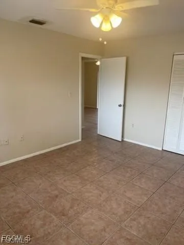 a bathroom with a granite countertop toilet a sink and mirror