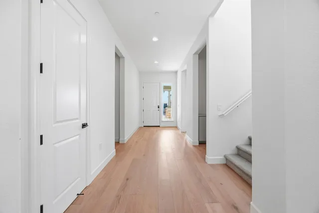 a view of hallway with wooden floor