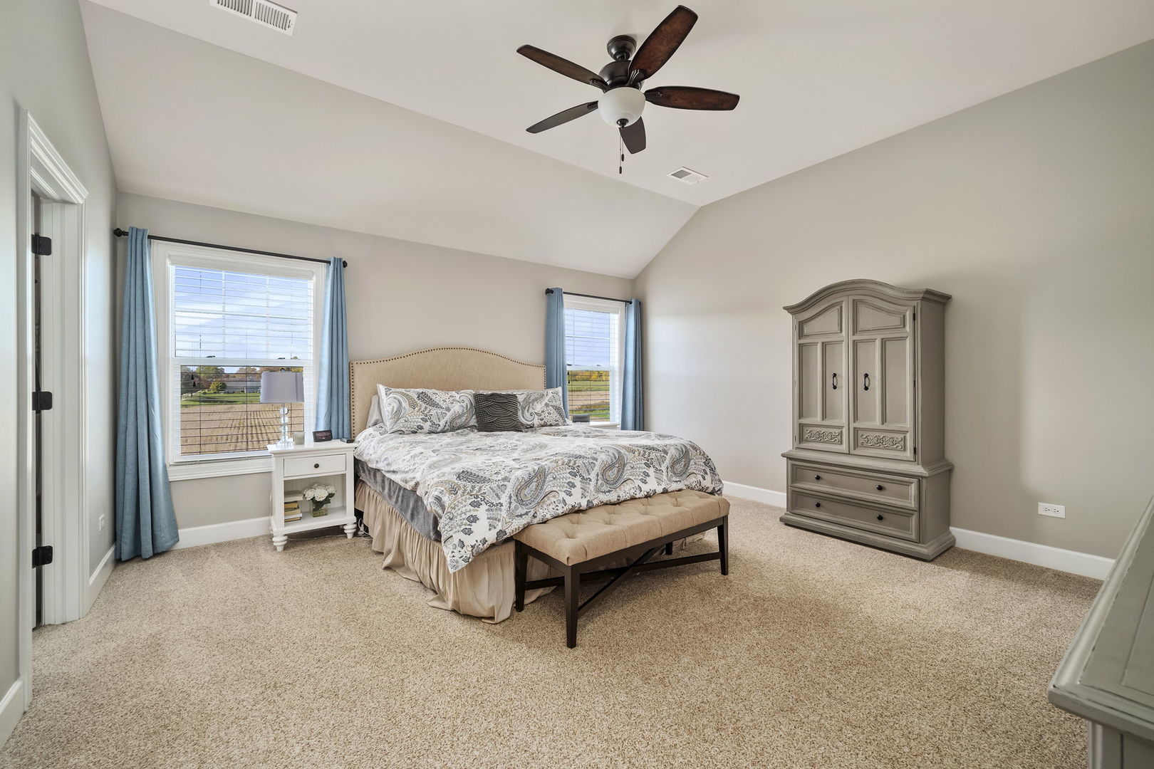 301 Arrowhead Drive Minooka, IL 60447 - Photo 20 of 43 a bedroom with a bed and a chandelier