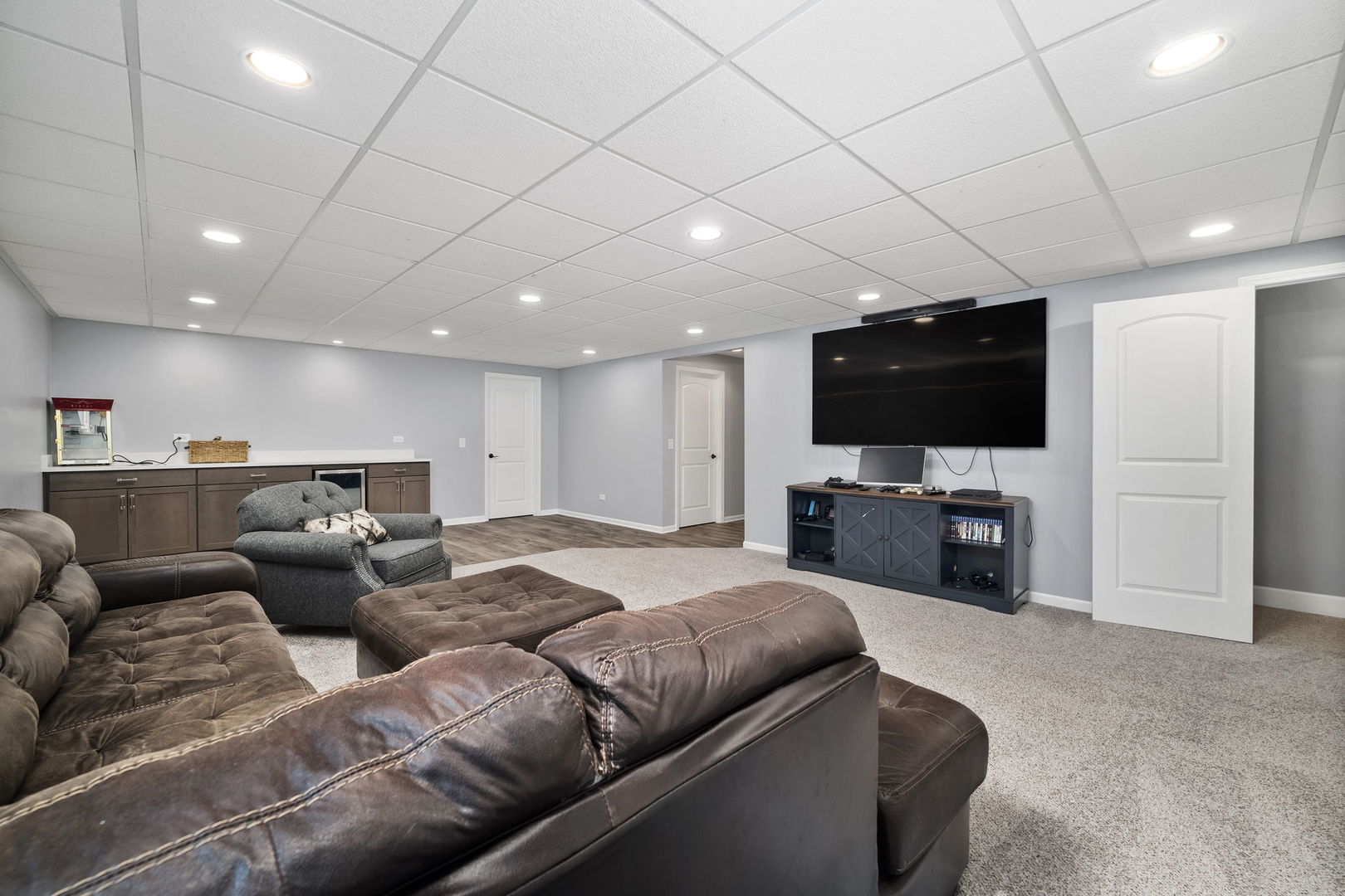 301 Arrowhead Drive Minooka, IL 60447 - Photo 28 of 43 a living room with furniture and a flat screen tv