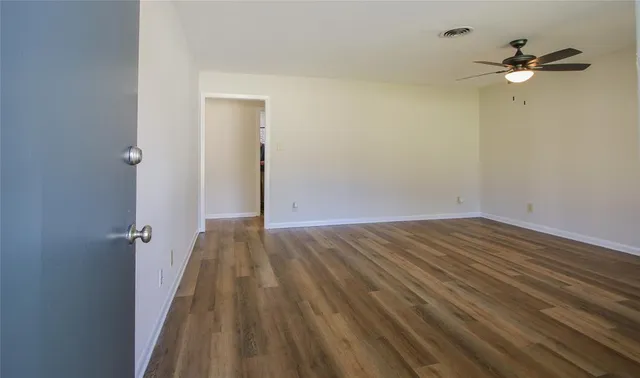 a view of a room with wooden floor