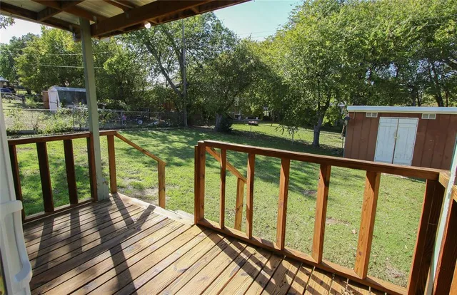 a view of balcony with wooden floor and outdoor seating