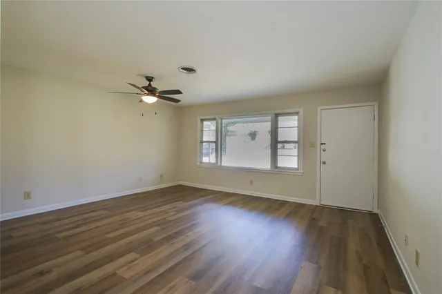 a view of a room with wooden floor and fan