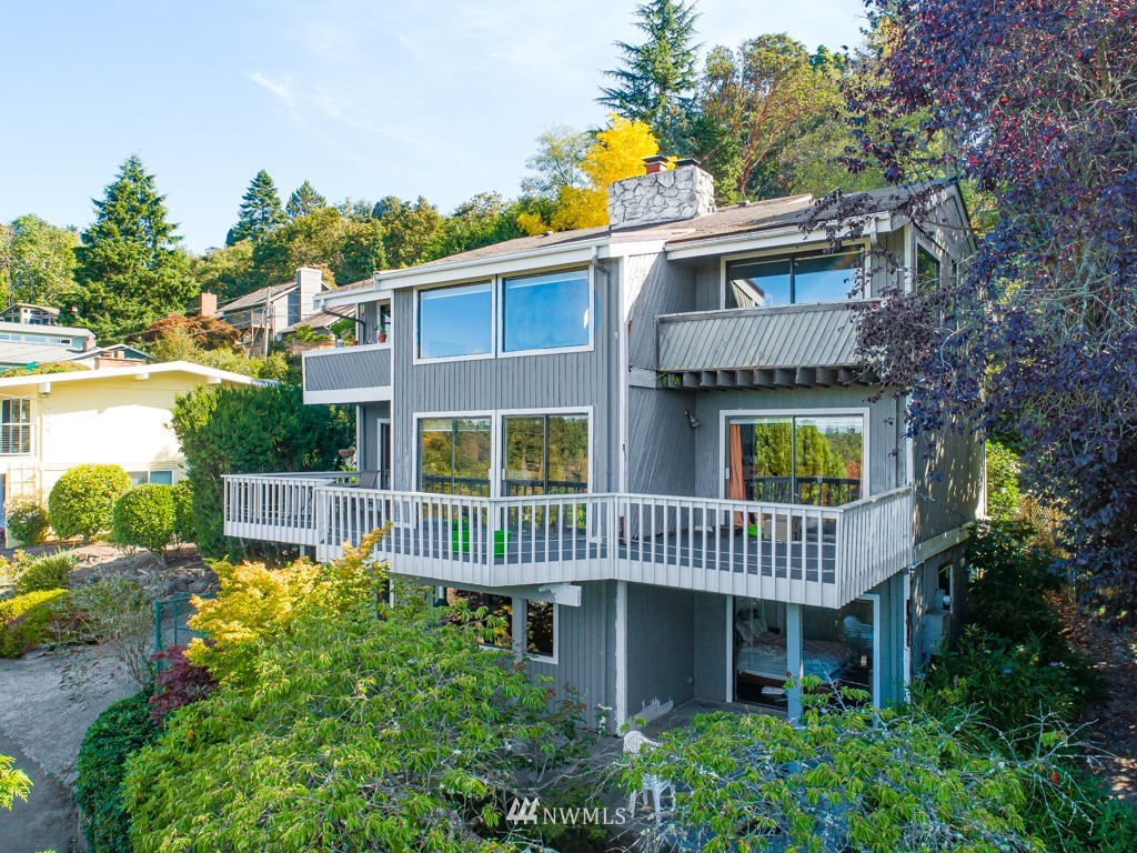 a front view of a house with a garden and plants