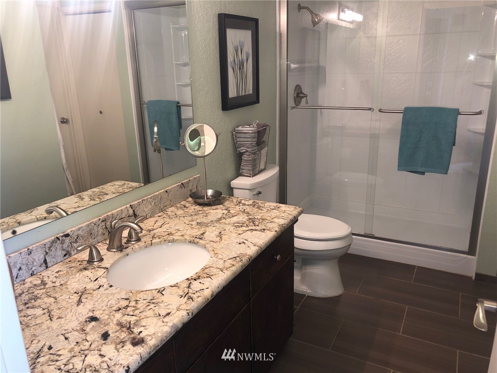 8438 Tillicum Road Southwest Seattle, WA 98136 - Photo 12 of 22 a bathroom with a granite countertop sink a toilet and mirror