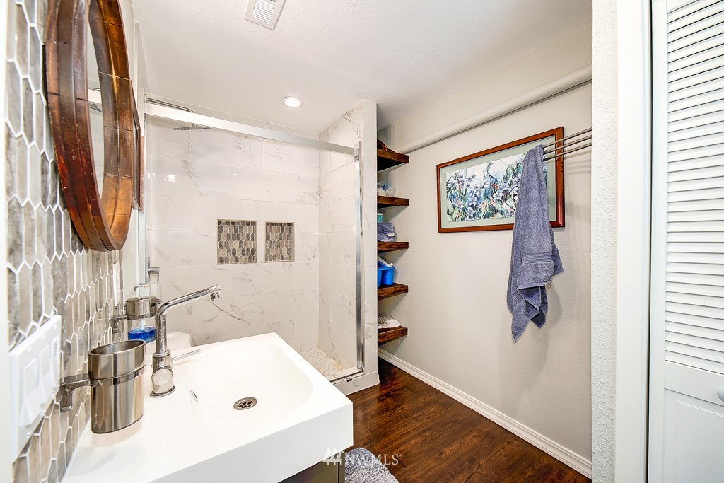 8438 Tillicum Road Southwest Seattle, WA 98136 - Photo 20 of 22 a bathroom with a sink vanity and tub