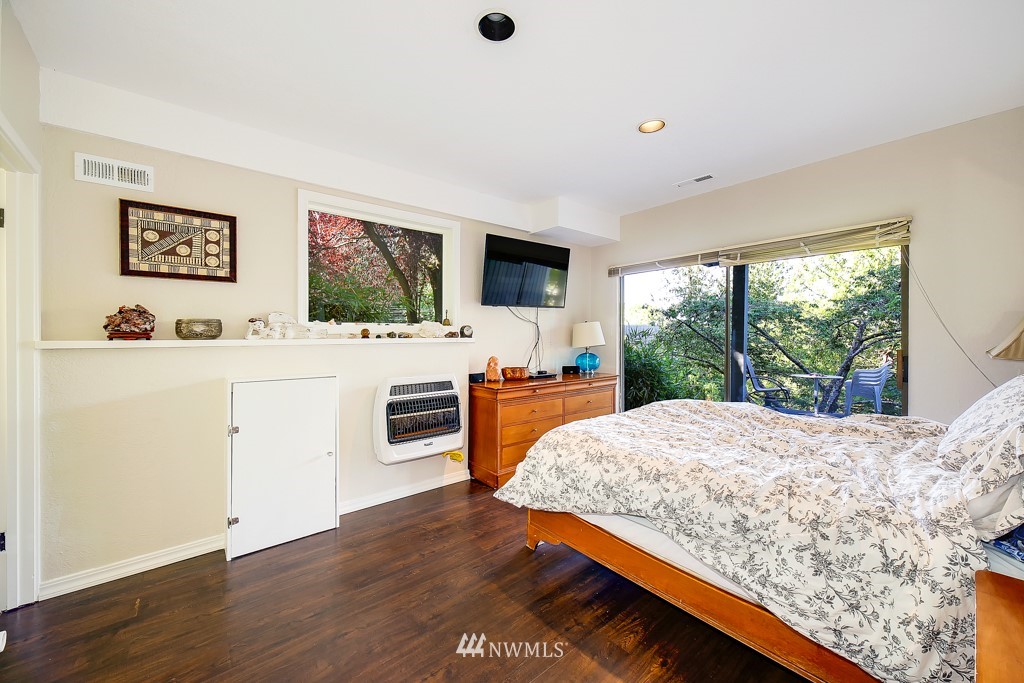 8438 Tillicum Road Southwest Seattle, WA 98136 - Photo 21 of 22 a bedroom with a bed and a flat screen tv