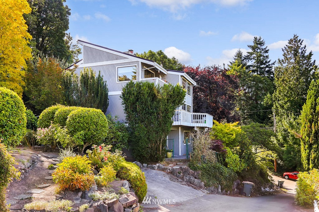 8438 Tillicum Road Southwest Seattle, WA 98136 - Photo 6 of 22 a front view of a house with a yard and a garden