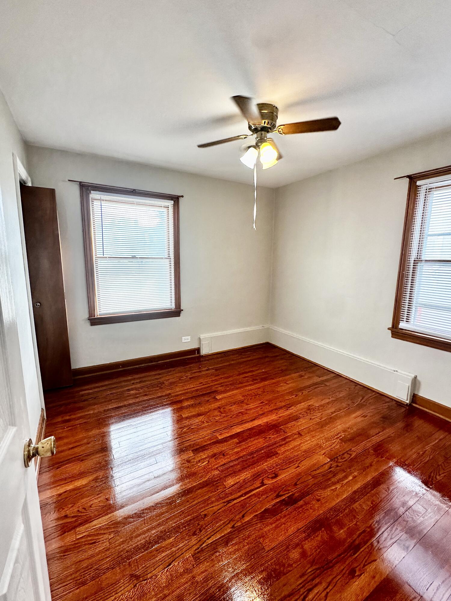 939 175th Place Hammond, IN 46324 - Photo 20 of 40 a view of empty room with wooden floor and fan