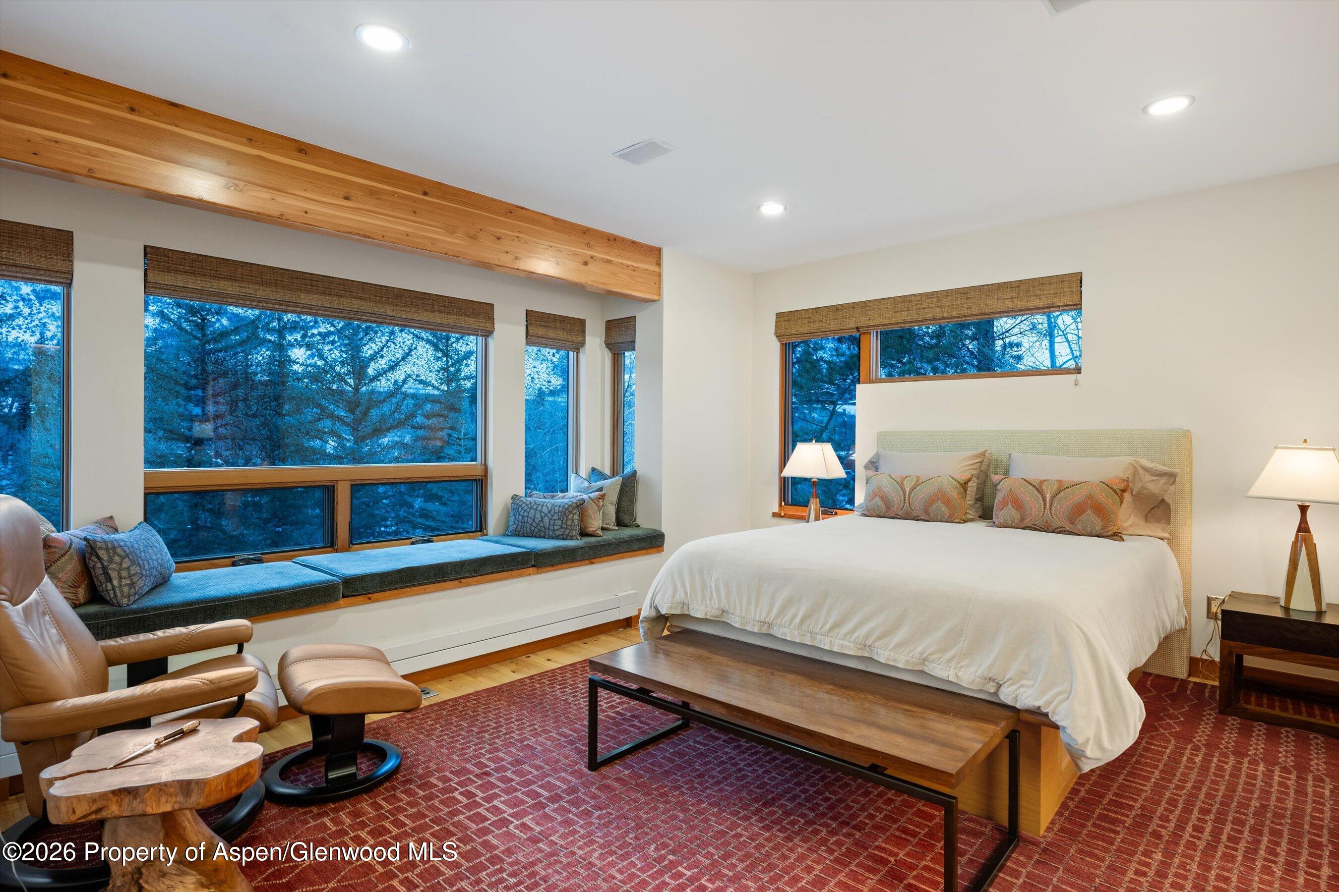 8389 Upper River Road Woody Creek, CO 81656 - Photo 19 of 27 a bedroom with a bed and large window