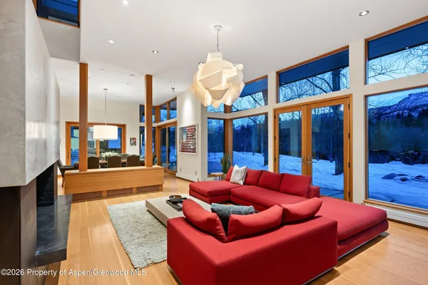 a living room with furniture a rug and a chandelier