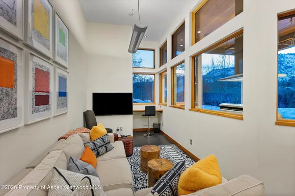 a living room with furniture and a flat screen tv