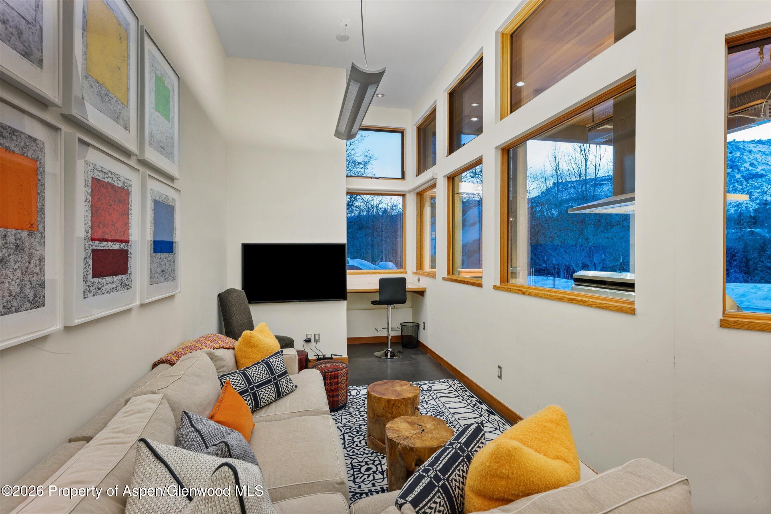 8389 Upper River Road Woody Creek, CO 81656 - Photo 8 of 27 a living room with furniture and a flat screen tv
